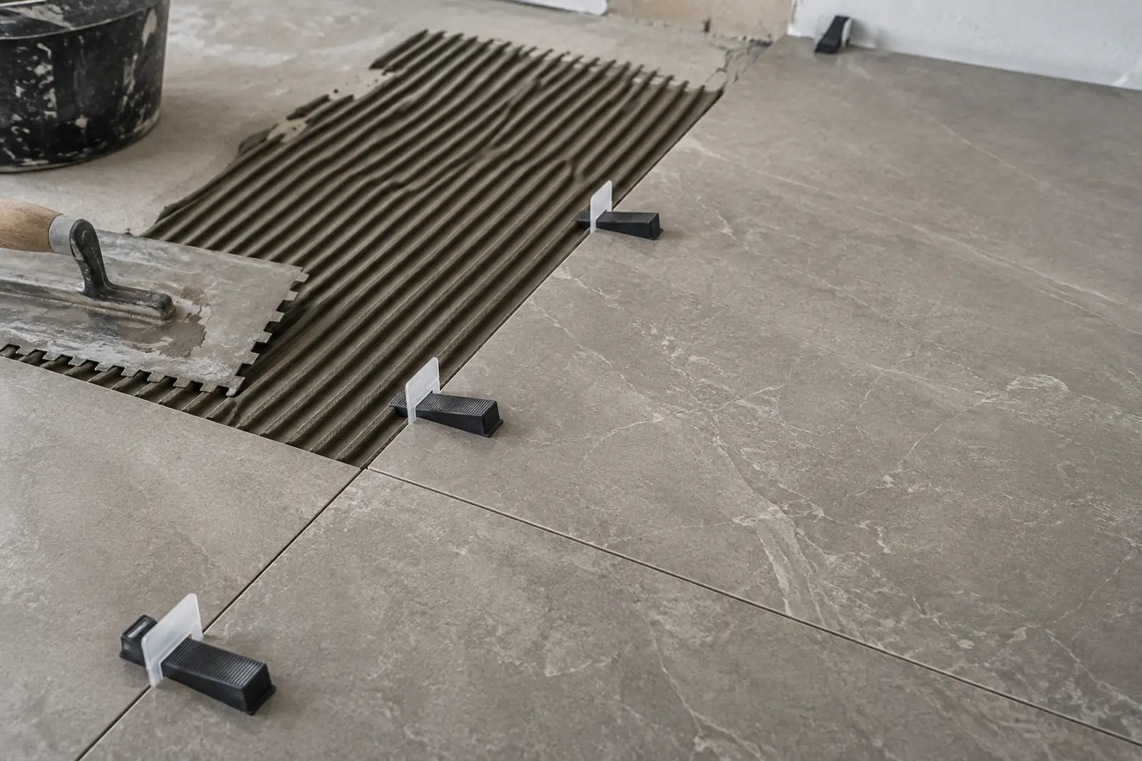 Porcelain floor tile installation in progress
